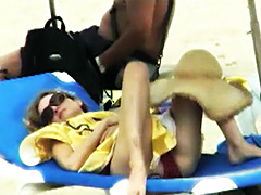Heather Graham lying at the beach in a..