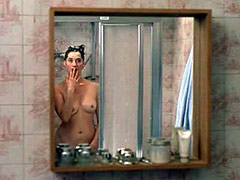 Naked Emmanuelle Devos poses before a..