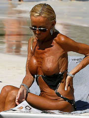 Donatella Versace topless in a bikini